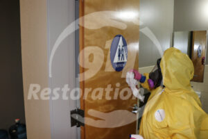 911 Restoration tech cleaning bathroom